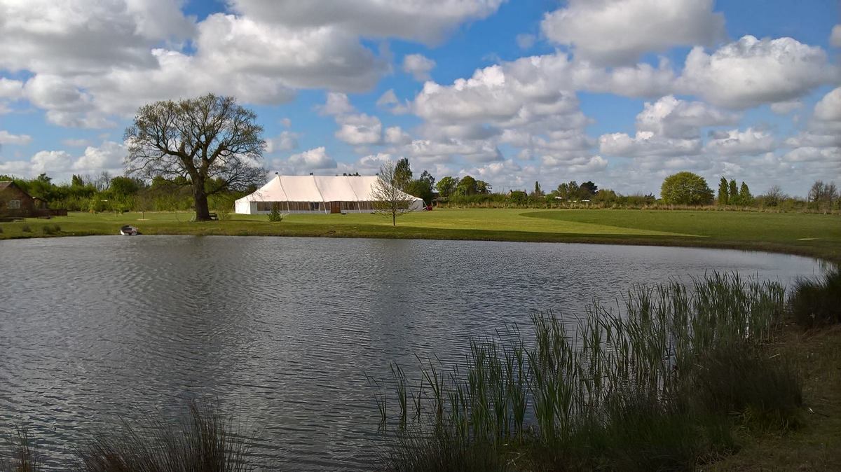 Traditional Marquee by a lake and golf club in Essex