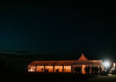 Night time exterior shot of a clear span marquee and a chinese hat marquee | County Marquees East Anglia