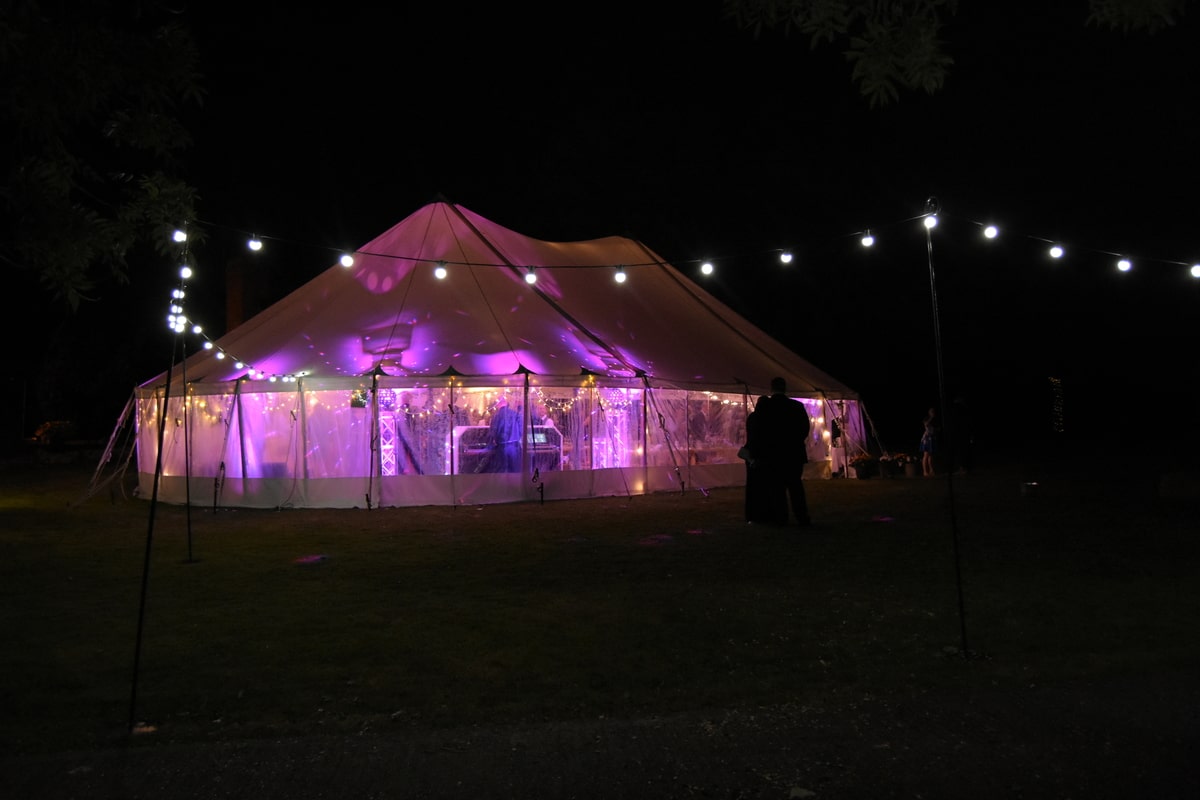 Exterior night time shot of sail cloth marquee with lights for Essex wedding | County Marquees East Anglia