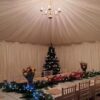 Christmas decorated tables in a traditional marquee
