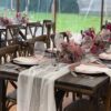 Reclaimed wood trestle tables being decorated