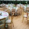 Round decorated tables in a transparent marquee