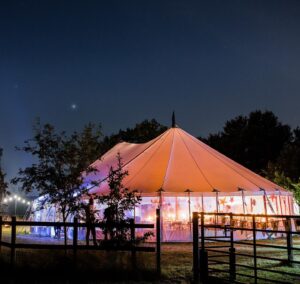 exterior view of a clear span marquee hire at night
