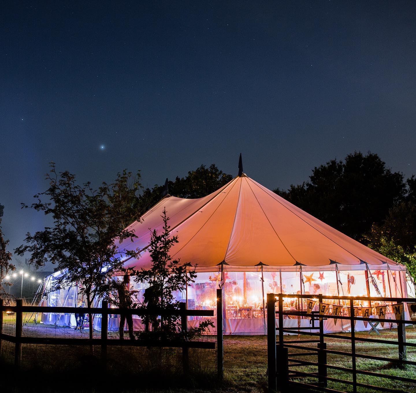 exterior view of a clear span marquee hire at night