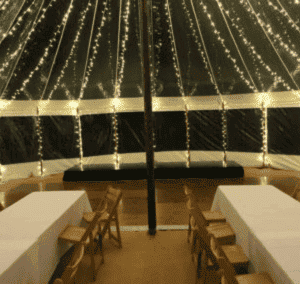 black stage with black skirt by county marquees