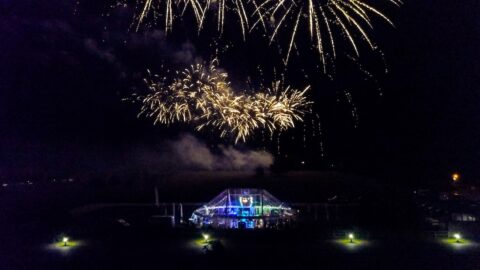 Fireworks seen above transparent marquee hire at night
