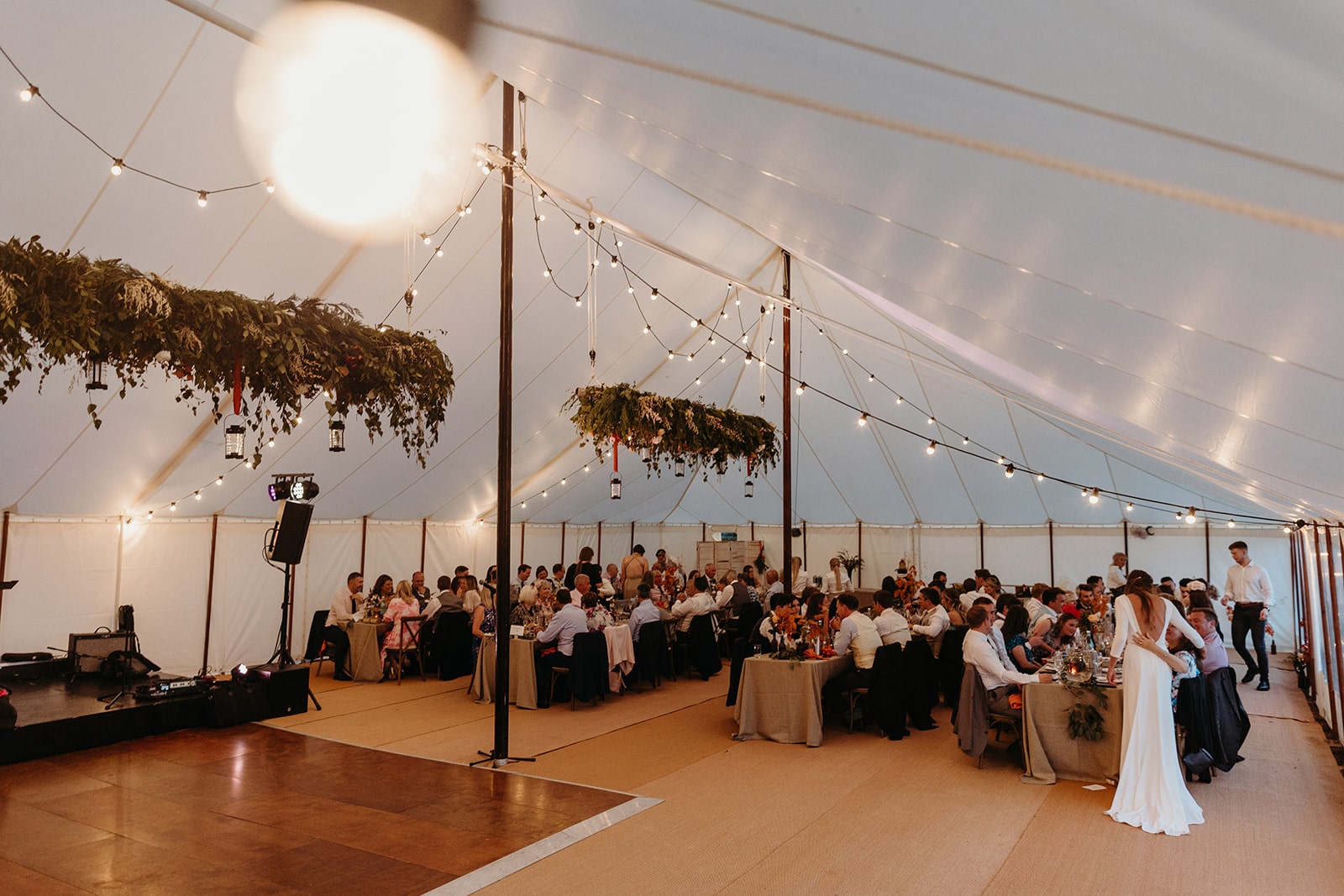 Summer marquee full of people during a wedding