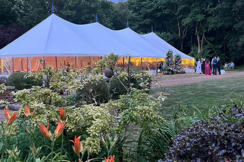 Elegant marquee wedding setup in Essex showcasing 2026 wedding trends with zoned seating, ambient lighting and styled dining areas