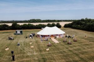 Finished marquee installation from above, with marquee on grass field